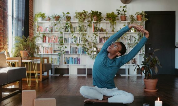 a man is doing yoga in a living room